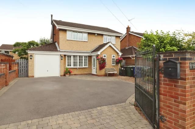A gated driveway leads up to the detached property for sale at £325,000.