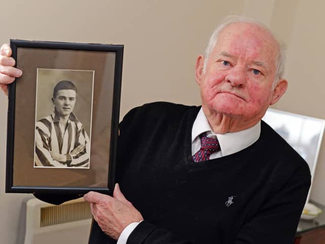 Michael Killourhy, holds a picture of his late father Michael 'Mick' Killourhy.