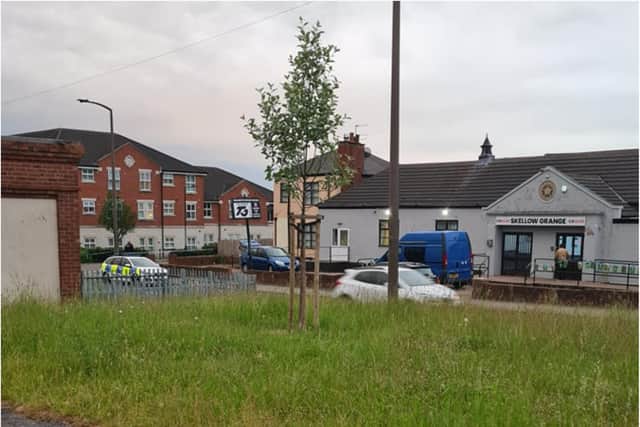A number of police and ambulances are at the scene.