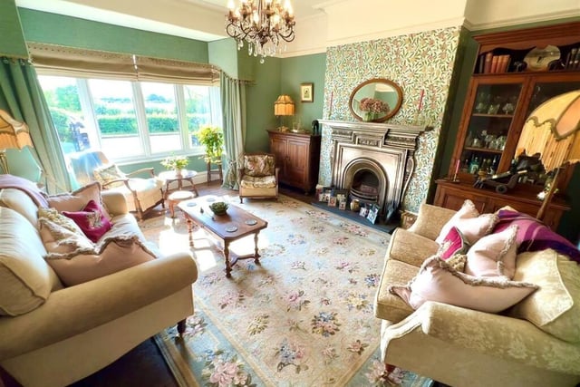 A stunning bay-fronted reception room with feature fireplace.