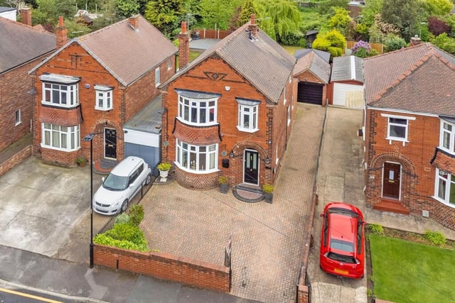 The house is set well back from the road with a large enclosed and paved area to the front.