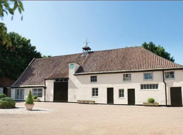 The property also has various outbuildings including a Grade-II listed banquet hall.