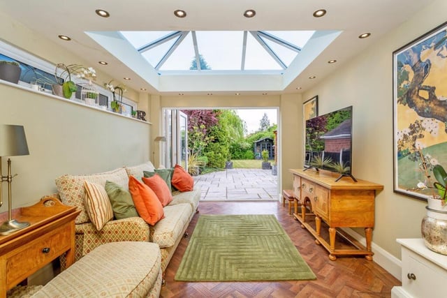 This versatile space is open plan to the dining room, with bi-fold doors out to the patio and garden.