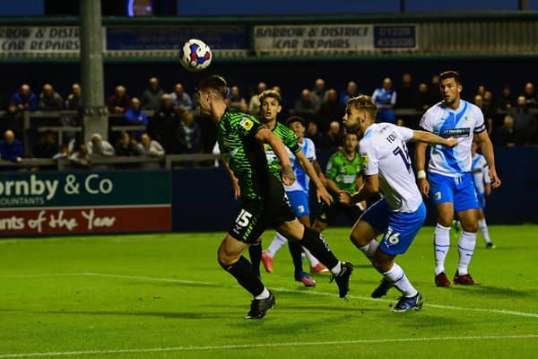Doncaster's Adam Long heads at goal against Barrow.