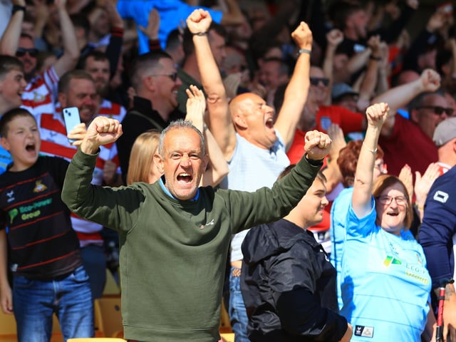 Doncaster Rovers fans celebrate as the full-time whistle blows