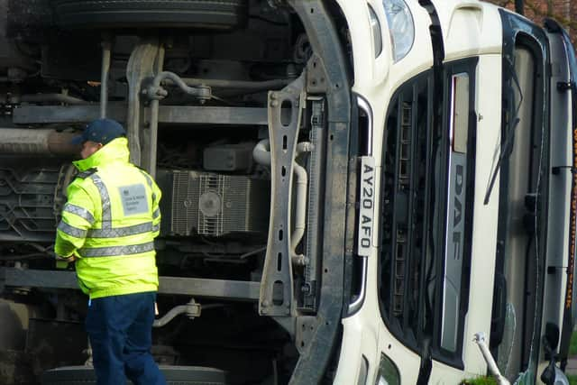 The lorry tipped over onto its side, with emergency crews racing to the scene. (Photo: Andrew Morton).