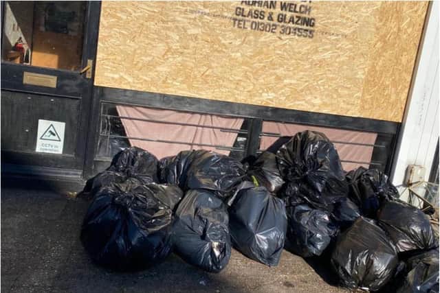 PIles of black bags filled with rubbish from the shutdown beauty business have been dumped outside the shop.