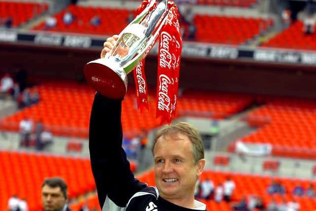 Sean O'Driscoll celebrates with the play-off trophy