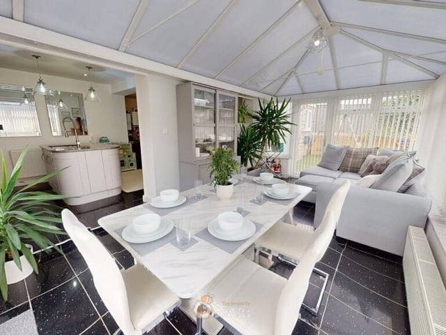 A stunning conservatory has views of the garden.