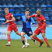 John Bostock holds off Wycombe Wanderers' Anis Mehmeti. Picture: Gareth Williams/AHPIX LTD