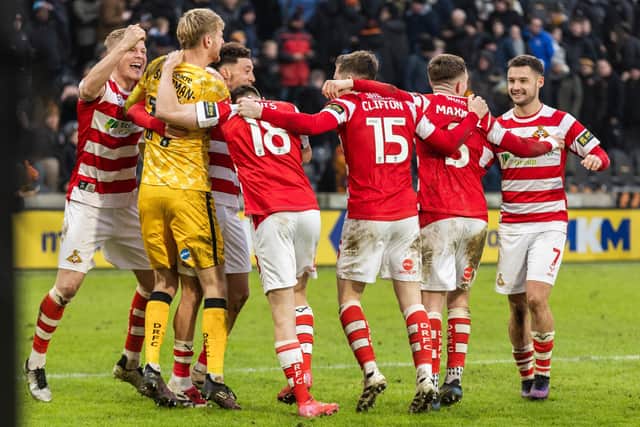 Doncaster Rovers players celebrate the win over Hull in round three.