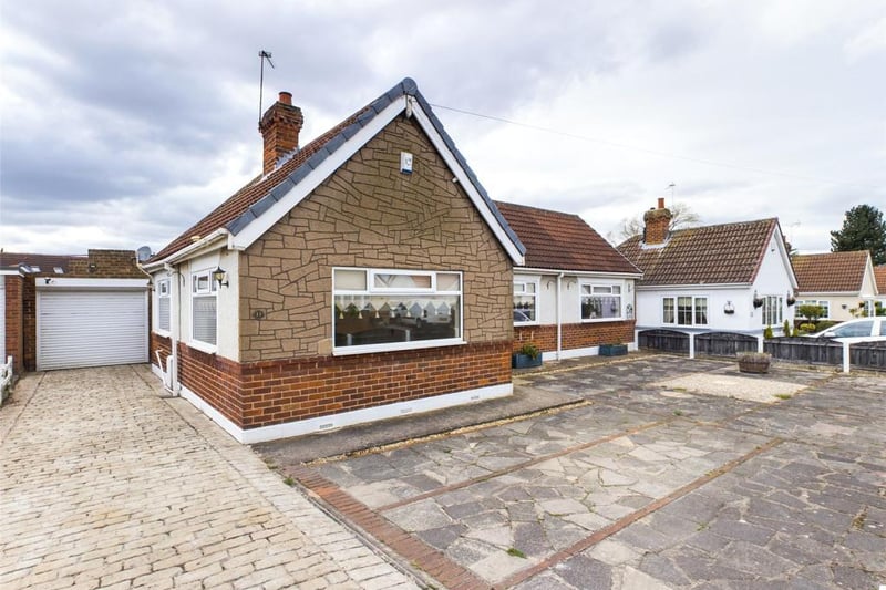 Paved front garden and driveway with access to the garage
