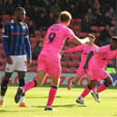 Kieran Agard celebrates scoring the opening goal against Rochdale.