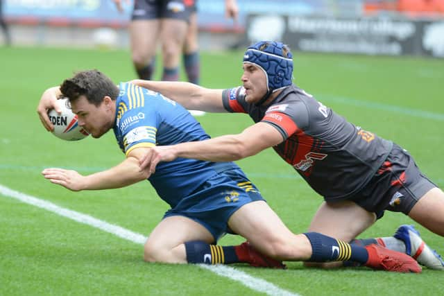 Matty Beharrell goes over for the game's opening try despite the attentions of Luke Cresswell. Photo: Rob Terrace