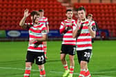 Doncaster Rovers' players react to their penalty shoot-out loss to Man United's under-21s.