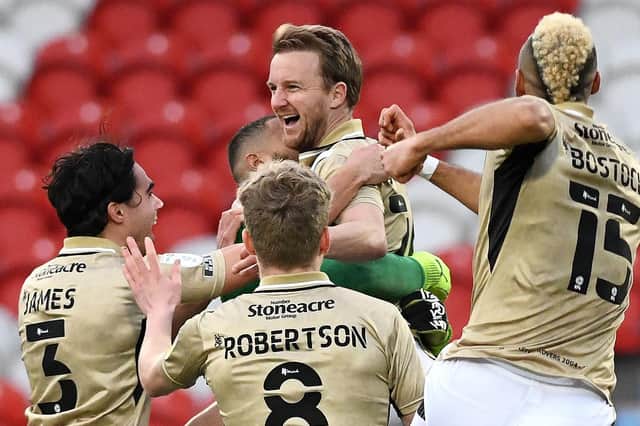 James Coppinger is mobbed by his teammates after his sensational equaliser against Hull City. Photo: Andrew Roe