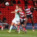 Mo Faal (far right) heads at goal for Doncaster Rovers