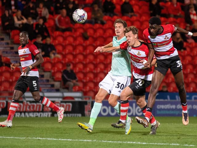 Mo Faal (far right) heads at goal for Doncaster Rovers