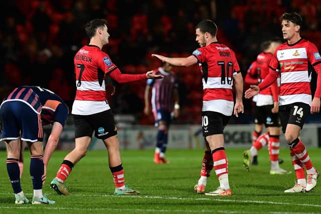 Luke Molyneux celebrates his goal with Tommy Rowe and Harrison Biggins. Picture: Andrew Roe/AHPIX LTD