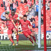 Tommy Rowe celebrates his winning goal against Morecambe. Photo: Howard Roe/AHPIX LTD