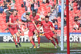 Tommy Rowe celebrates his winning goal against Morecambe. Photo: Howard Roe/AHPIX LTD