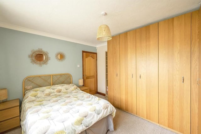 Bedroom 1 - A double room with a rear facing double glazed window with garden views, fitted wardrobes providing hanging and storage space with coordinating drawers and a central heating radiator. A door gives access to the ensuite.