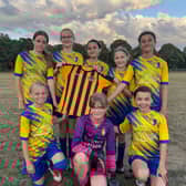Edenthorpe U12 Girls holding the Doncaster Schools football top.
