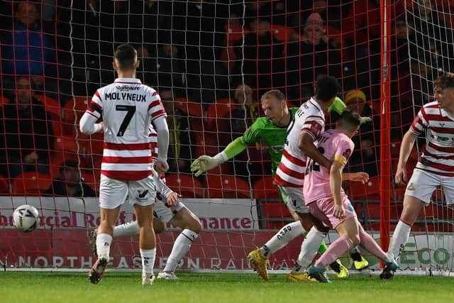 Jonathan Mitchell can't keep out Gold Omotayo's header. Picture: Howard Roe/AHPIX.com