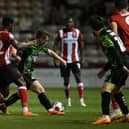 Doncaster's James Maxwell battles with TJ Eyoma of Lincoln.