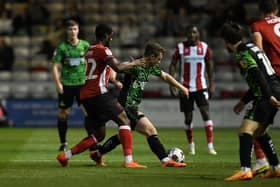 Doncaster's James Maxwell battles with TJ Eyoma of Lincoln.
