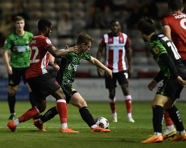 Doncaster's James Maxwell battles with TJ Eyoma of Lincoln.