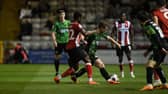 Doncaster's James Maxwell battles with TJ Eyoma of Lincoln.