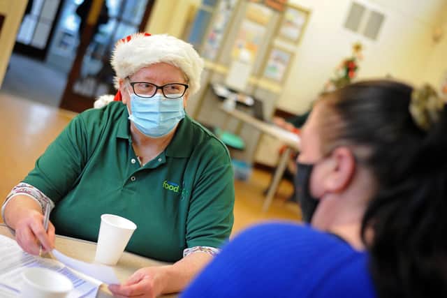 Volunteer listener Karen Lovell, pictured speaking with a client.