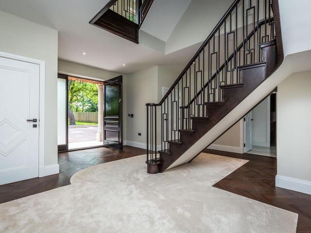 The spacious entrance hall with bespoke staircase.