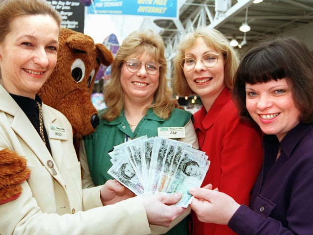 Asda worker Joan Umpleby (dressed as a bear), Doncaster Asda customer service manager Wendy Taylor (left), and Asda employee Jan Rooke present cheques and cash to the value of £910 to Patricia Revell and Jackie Talbot, chairman  and secretary/treasurer respectively of Children with Autism pictured back in 1998