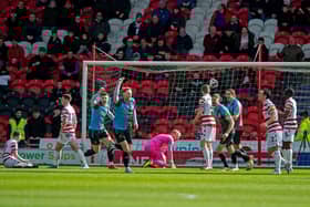 Mitch Pinnock celebrates Northampton's opener after a Jonathan Mitchell error.