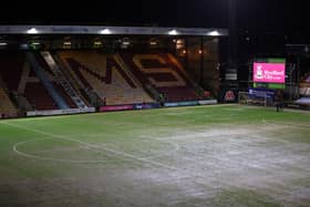 A member of ground staff attempts to roll the pitch at Valley Parade. (Photo by George Wood/Getty Images)