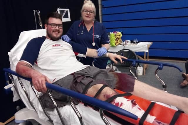 Volunteer 'patient' Ryan Farbrace, and Carol Orr, education lead for medicine and emergency nurse practitioner, at the We Care - Into the Future health careers event at Doncaster Dome