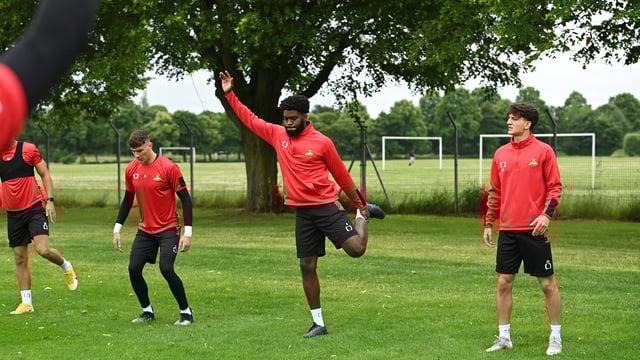 New signing Ro-Shaun Williams (centre) stretches alongside Louis Jones and Lirak Hasani