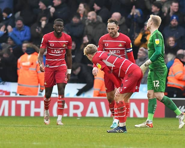 Doncaster's players look dejected after conceding their third goal. Photo: Andrew Roe/AHPIX LTD