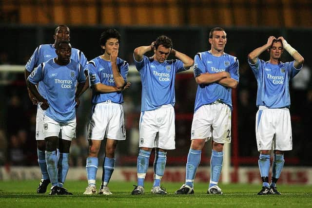 Manchester City players look dejected on their way to a 3-0 defeat on penalties to Doncaster. Photo by Michael Steele/Getty Images
