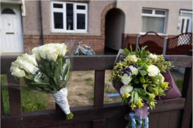 Floral tributes have been left at the house in Welfare Road, Woodlands. (Photo: SWNS).
