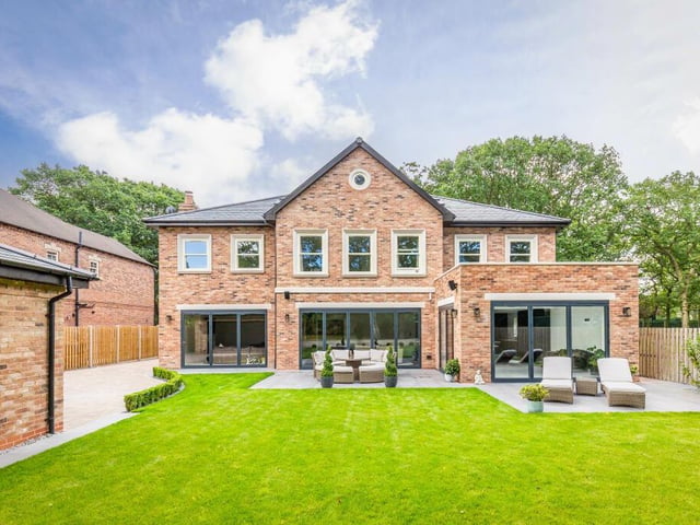 The rear lawned garden with large patio seating areas.