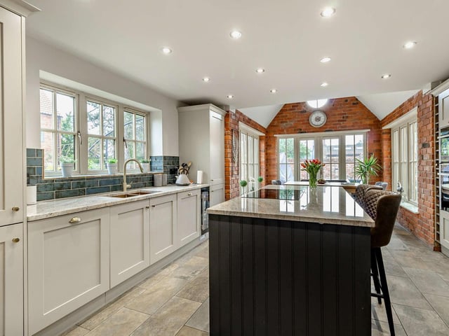 A showcase kitchen with diner features a large central island.