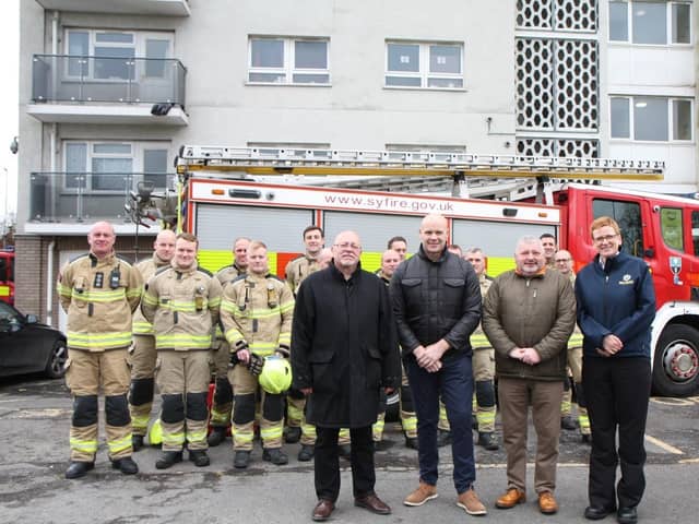 Cllr Glyn Jones (Deputy Mayor and Cabinet Member for Housing and Business); Chris Margrave (Director of Property Services at St Leger Homes); Dave Wilkinson (Chair of the St Leger Homes Board); and Cath Toovey (South Yorkshire Fire and Rescue Area Manager); with firefighters from South Yorkshire Fire and Rescue.