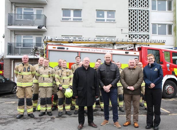 Cllr Glyn Jones (Deputy Mayor and Cabinet Member for Housing and Business); Chris Margrave (Director of Property Services at St Leger Homes); Dave Wilkinson (Chair of the St Leger Homes Board); and Cath Toovey (South Yorkshire Fire and Rescue Area Manager); with firefighters from South Yorkshire Fire and Rescue.