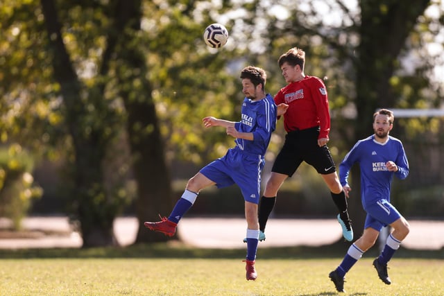 Billy Smith (Wymering, red) wins this header against FC Strawberry. Picture: Chris Moorhouse