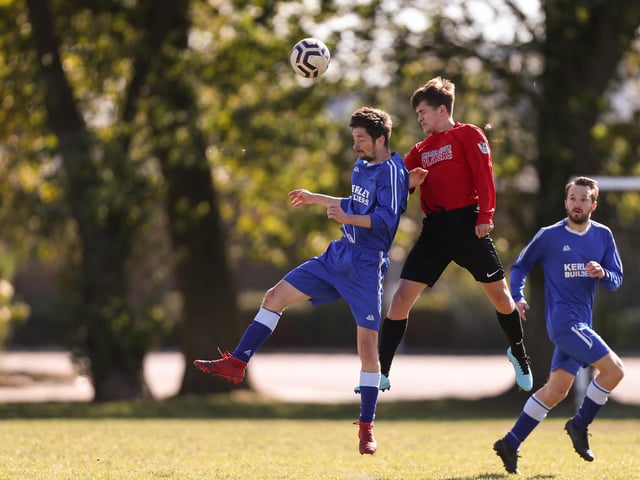 Billy Smith (Wymering, red) wins this header against FC Strawberry. Picture: Chris Moorhouse