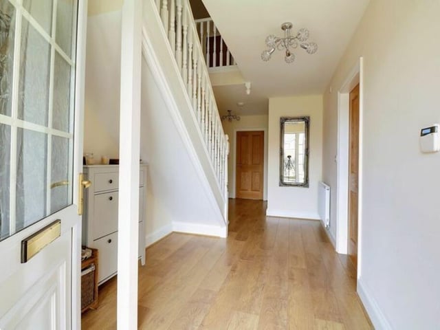 A spacious hallway links to all the main reception rooms.