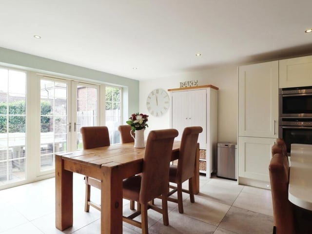 The dining area opens through to an outdoor patio, ideal for the summer.